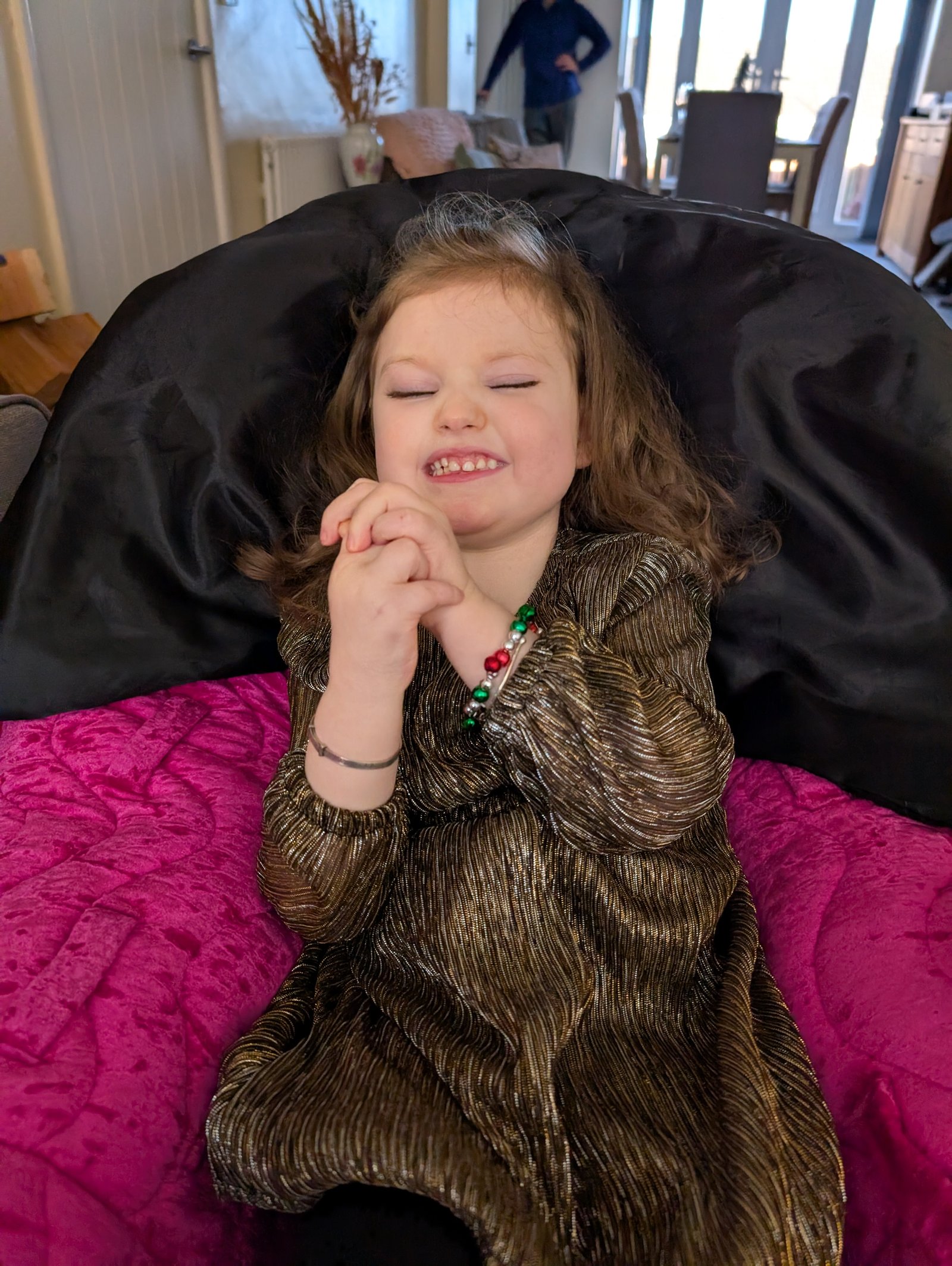 Grace in her gold Christmas dress, beaming